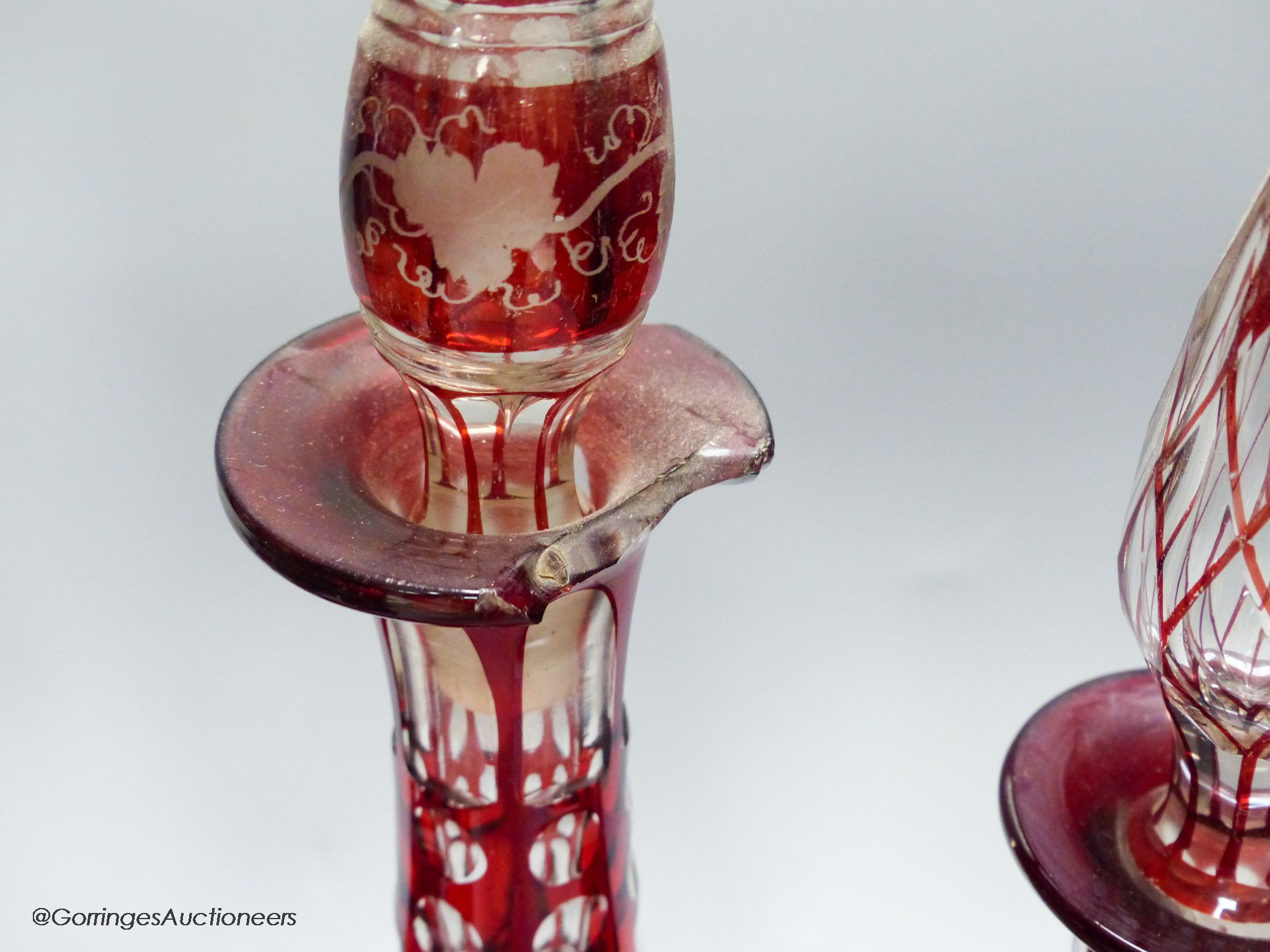 A collection of six Bohemian ruby flashed wheel engraved glass decanters, tallest 40cm, a similar spa beaker and liqueur glass